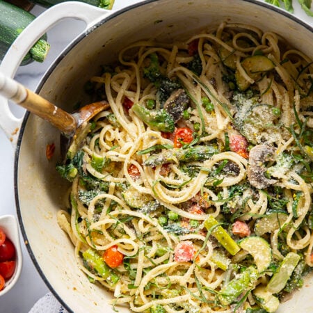 Loaded with a rainbow of spring vegetables and tossed in a creamy Parmesan sauce, this spring pasta primavera is easy to throw together and a beautiful pasta dish for any occasion.