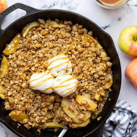 This skillet caramel apple crisp features tender apple slices in a rich homemade caramel sauce and topped with a buttery oat streusel topping. Enjoy this classic fall dessert warm from the oven with vanilla ice cream or whipped cream!