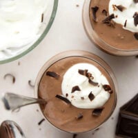 Rich and silky homemade chocolate pudding is easy to make from scratch and incredible with a scoop of fresh whipped cream and chocolate shavings on top.