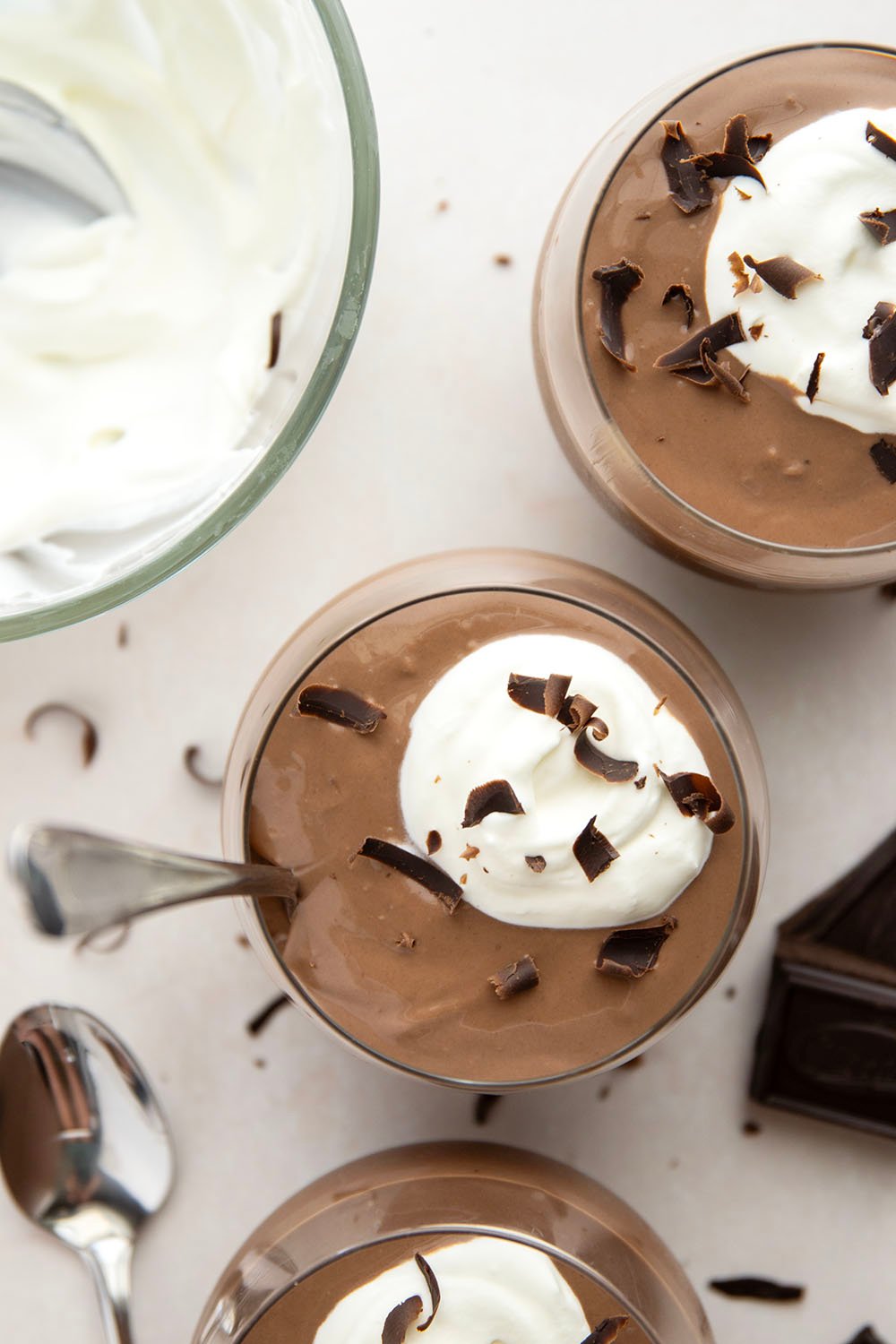 Rich and silky homemade chocolate pudding is easy to make from scratch and incredible with a scoop of fresh whipped cream and chocolate shavings on top.