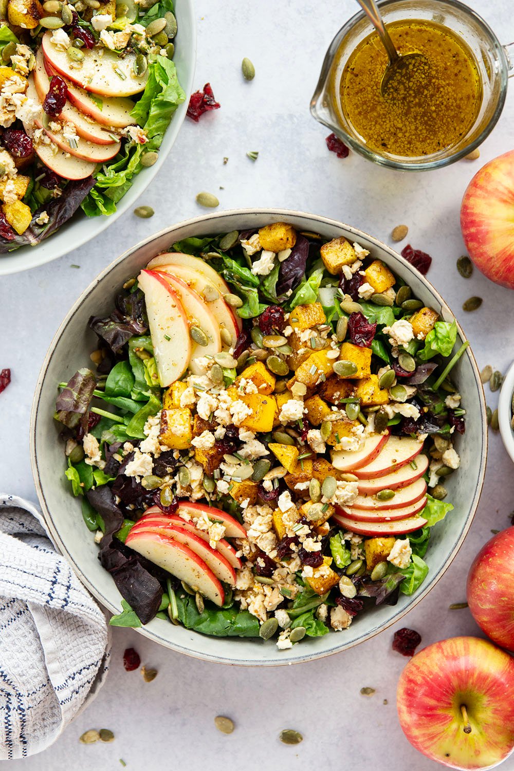 This roasted butternut squash salad is packed to capacity with all the fall works including spiced roasted butternut squash, crisp apple slices, crunchy pepitas, and a sweet maple vinaigrette drizzled on top.