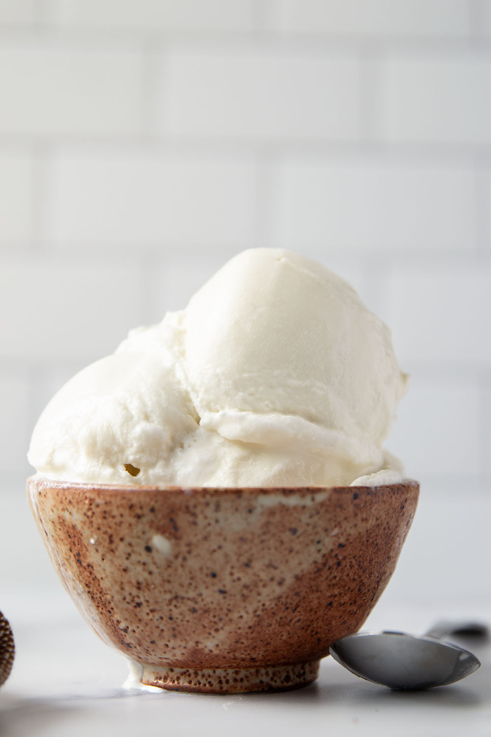 Smooth and creamy homemade vanilla ice cream that tastes better than any store-bought brand and only needs 4 basic ingredients! Load up this easy ice cream with all your favorite ice cream toppings.