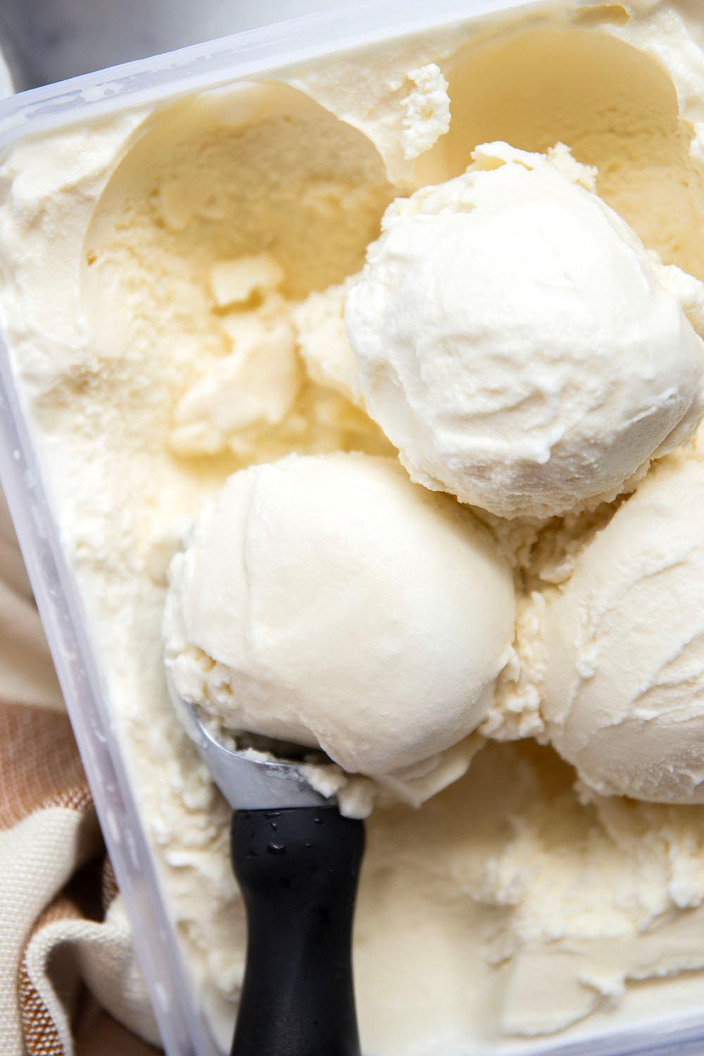 Smooth and creamy homemade vanilla ice cream that tastes better than any store-bought brand and only needs 4 basic ingredients! Load up this easy ice cream with all your favorite ice cream toppings.