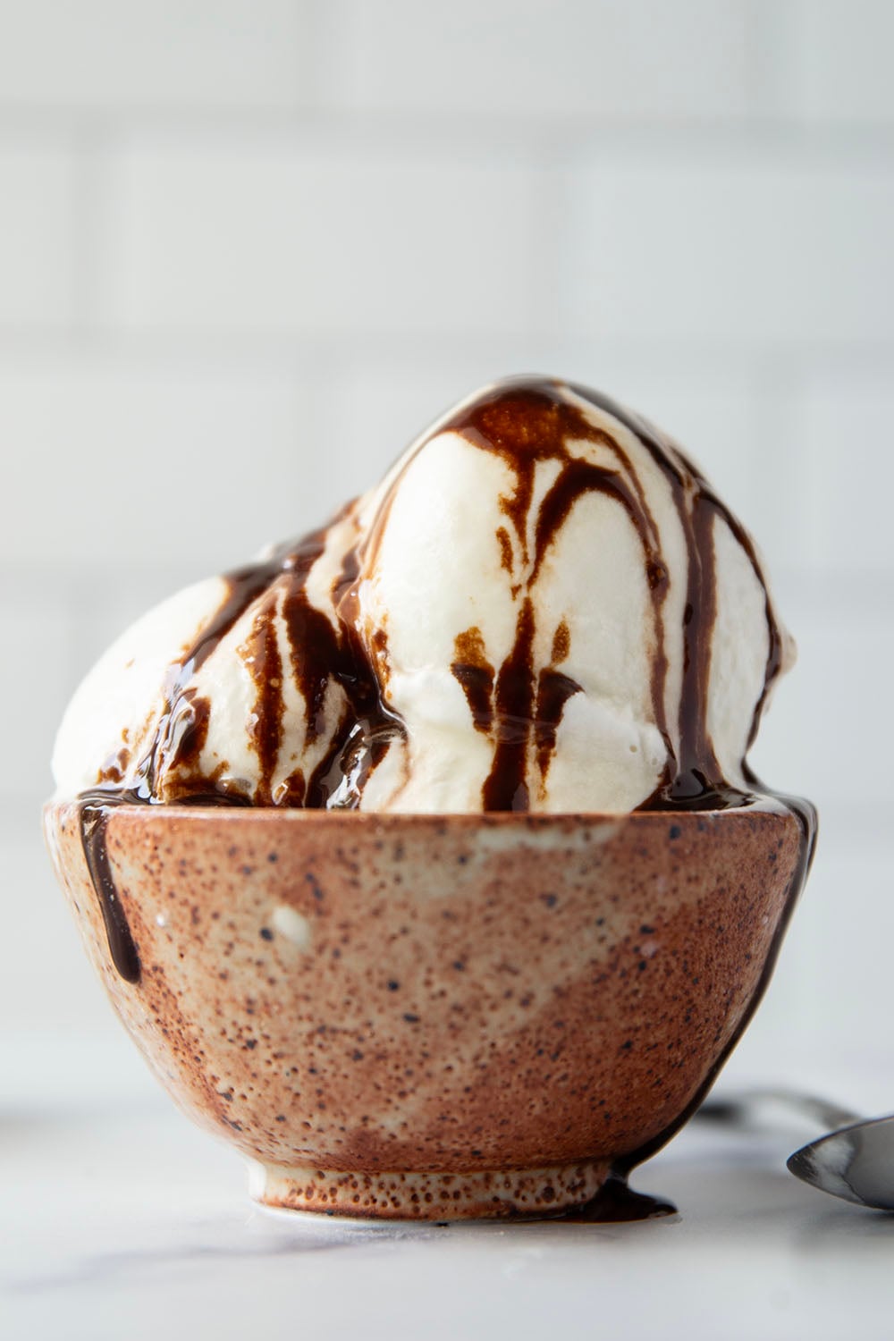 Smooth and creamy homemade vanilla ice cream that tastes better than any store-bought brand and only needs 4 basic ingredients! Load up this easy ice cream with all your favorite ice cream toppings.