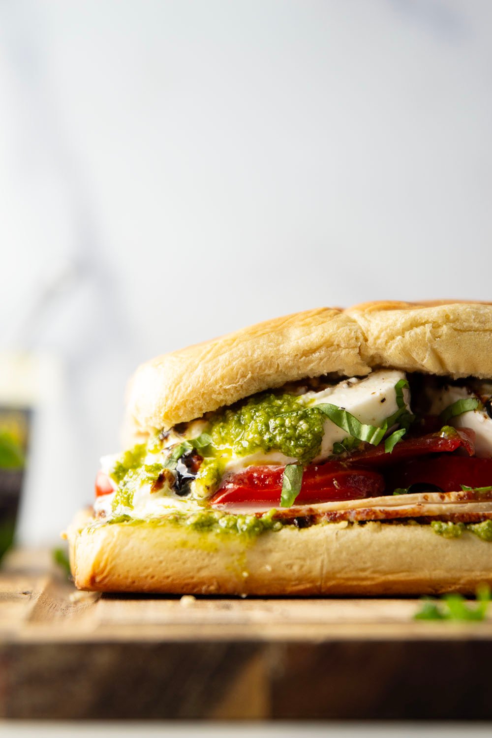 These caprese sliders feature herby basil pesto, sliced turkey, creamy burrata, and lots of fresh tomato slices layered between soft slider buns.