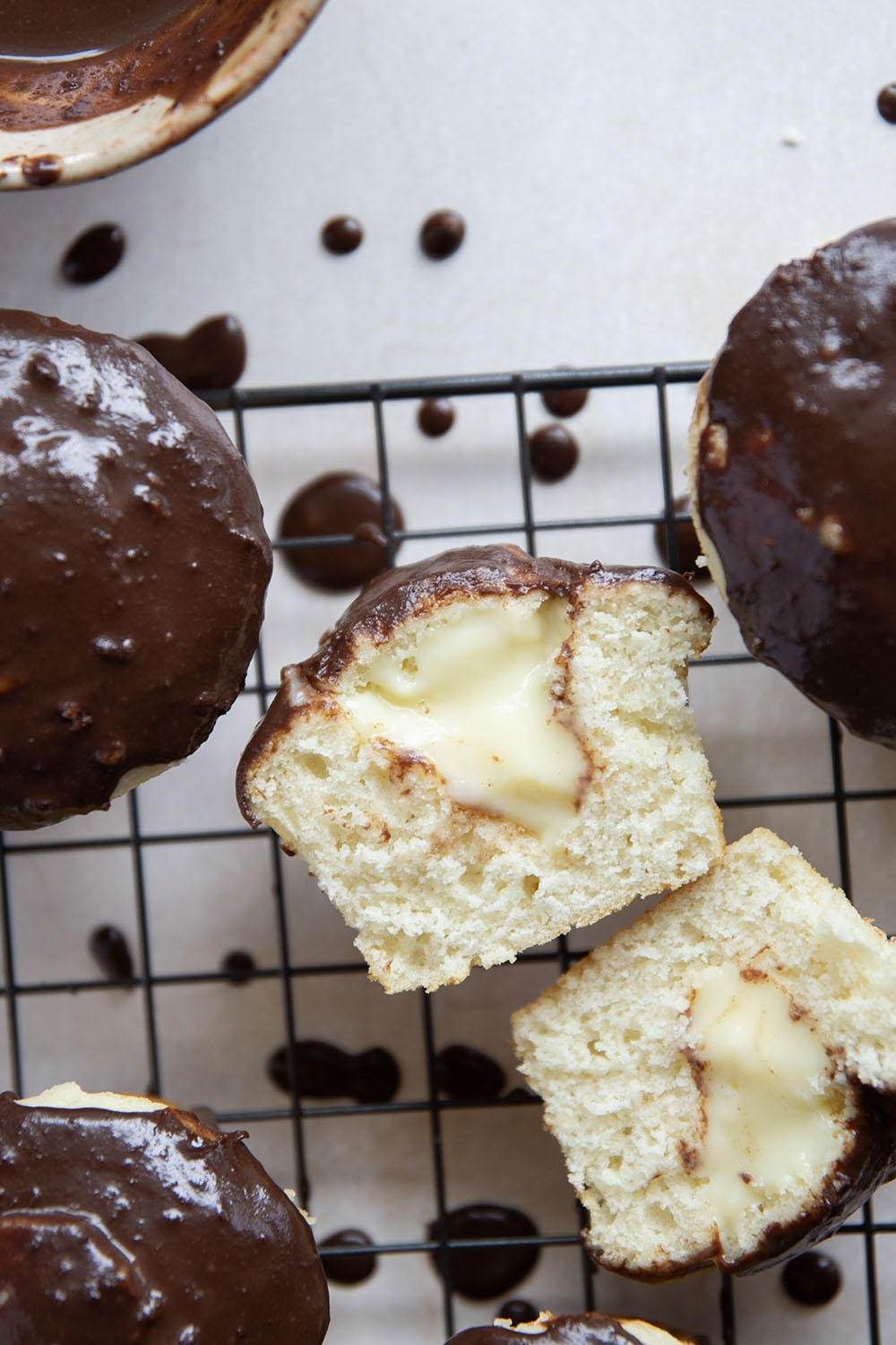 These Boston cream pie cupcakes feature soft and buttery white cupcakes filled with vanilla pastry cream and topped with rich chocolate ganache.