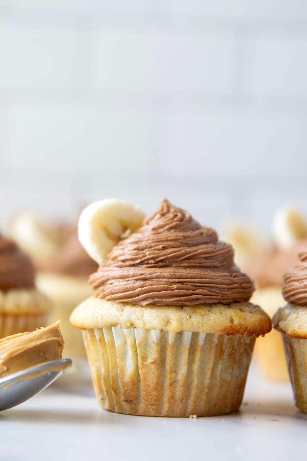 These super moist and fluffy banana cupcakes with chocolate peanut butter frosting piped high on top are about to be your new favorite cupcake flavor!