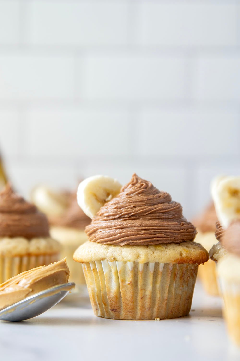 These super moist and fluffy banana cupcakes with chocolate peanut butter frosting piped high on top are about to be your new favorite cupcake flavor!