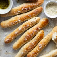 Learn how to make perfect homemade breadsticks with this easy recipe! Soft on the inside, crusty on the outside, and brushed in a garlic herb butter.