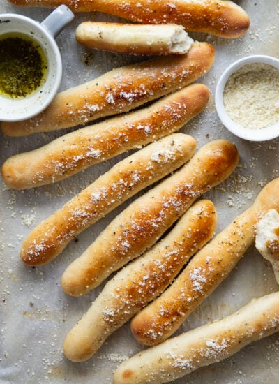 Learn how to make perfect homemade breadsticks with this easy recipe! Soft on the inside, crusty on the outside, and brushed in a garlic herb butter.