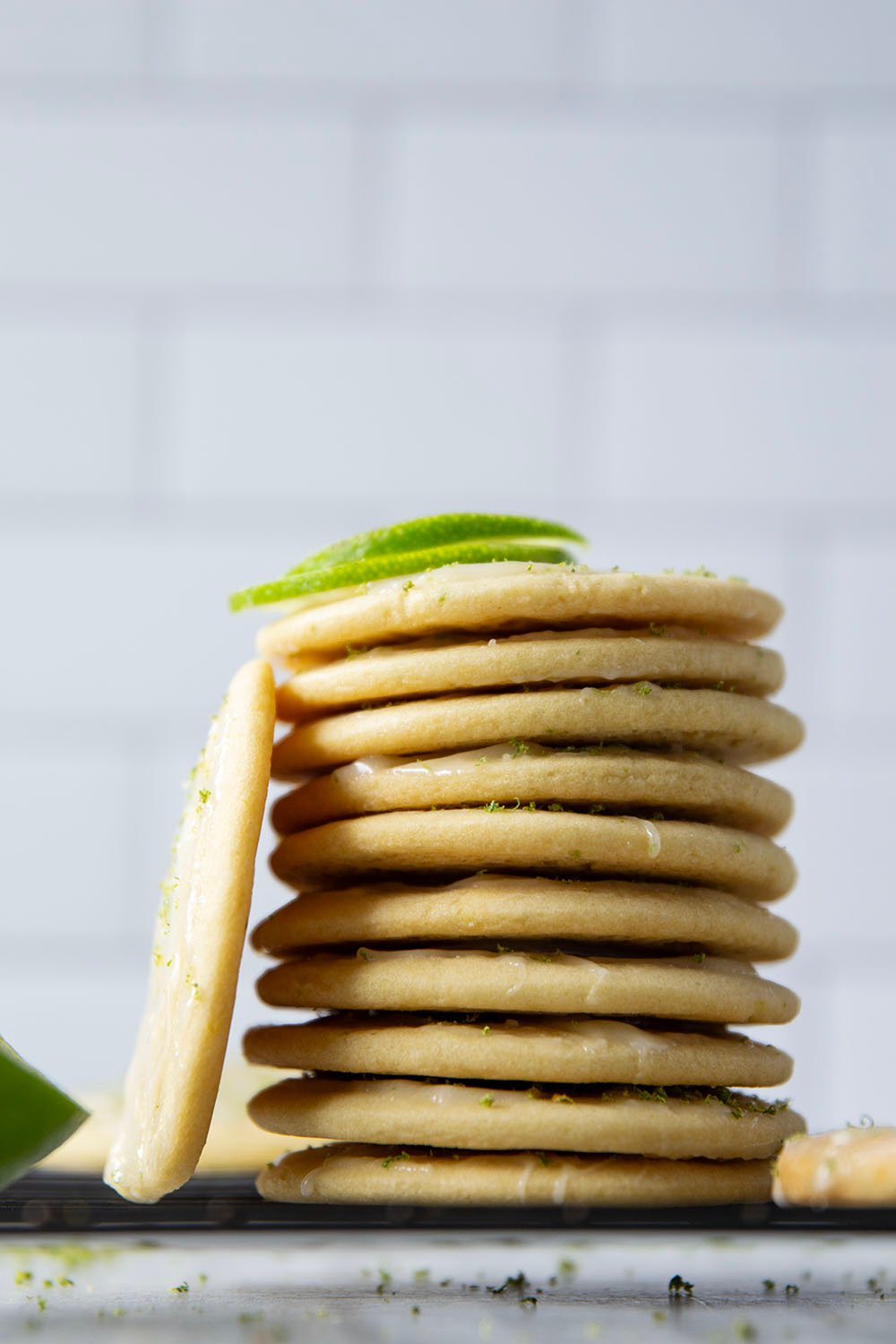 Soft, cake-like tea cakes are topped with a rich lime cream cheese glaze for the best little dessert or snack bite!