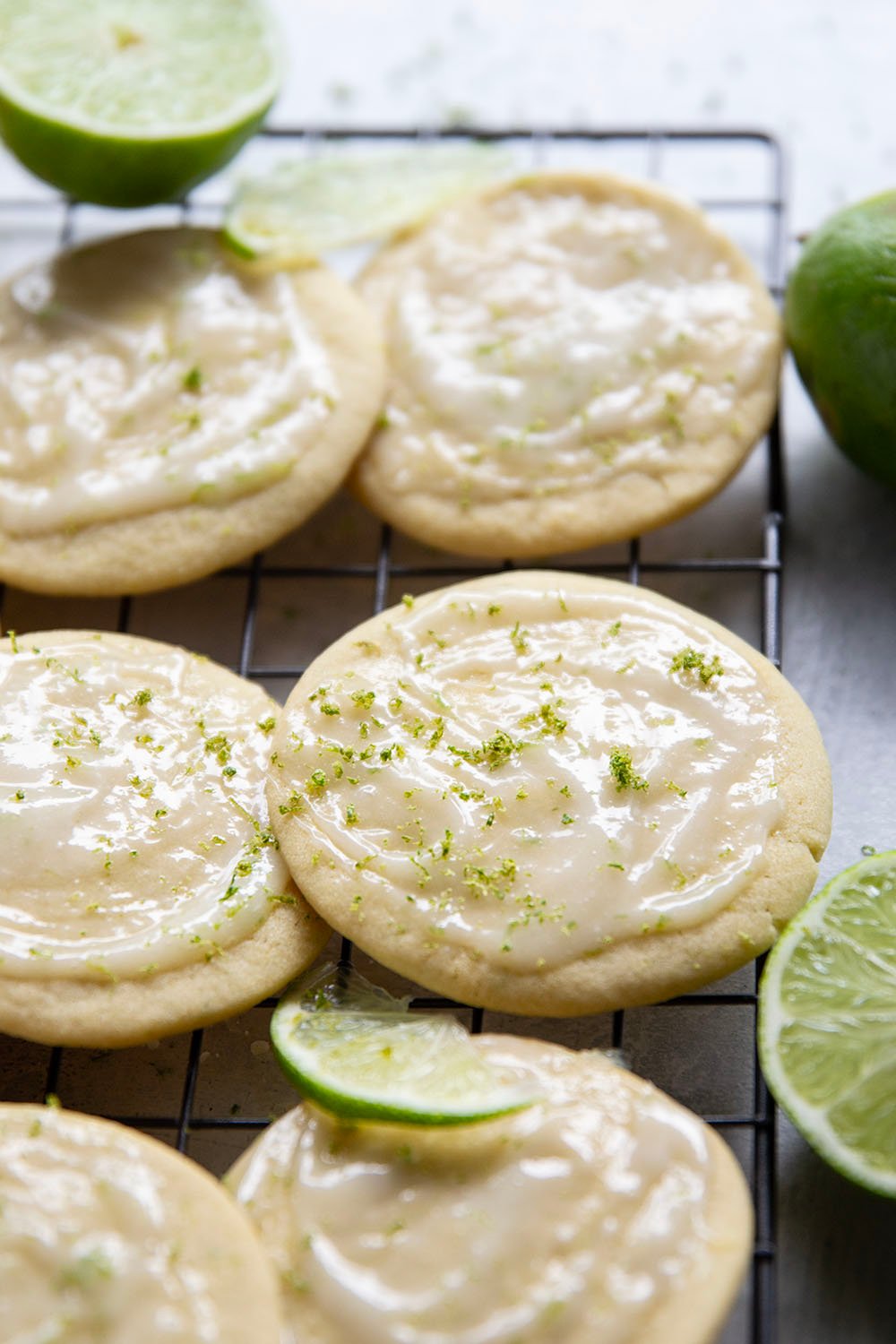 Soft, cake-like tea cakes are topped with a rich lime cream cheese glaze for the best little dessert or snack bite!