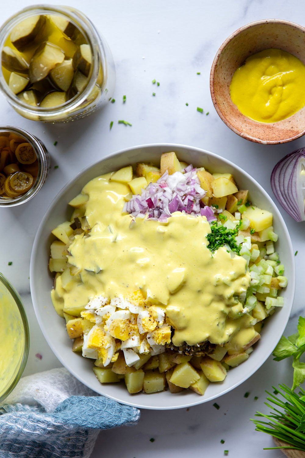 Texas potato salad features a tangy yellow mustard dressing coating tender potatoes with lots of pickled jalapenos for a kick of heat.