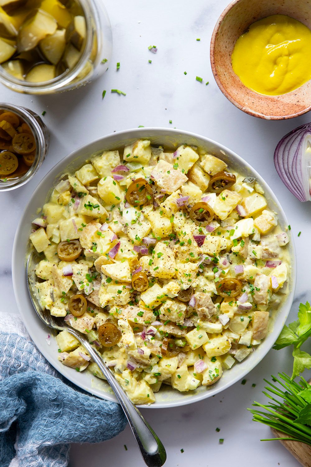 Texas potato salad features a tangy yellow mustard dressing coating tender potatoes with lots of pickled jalapenos for a kick of heat.