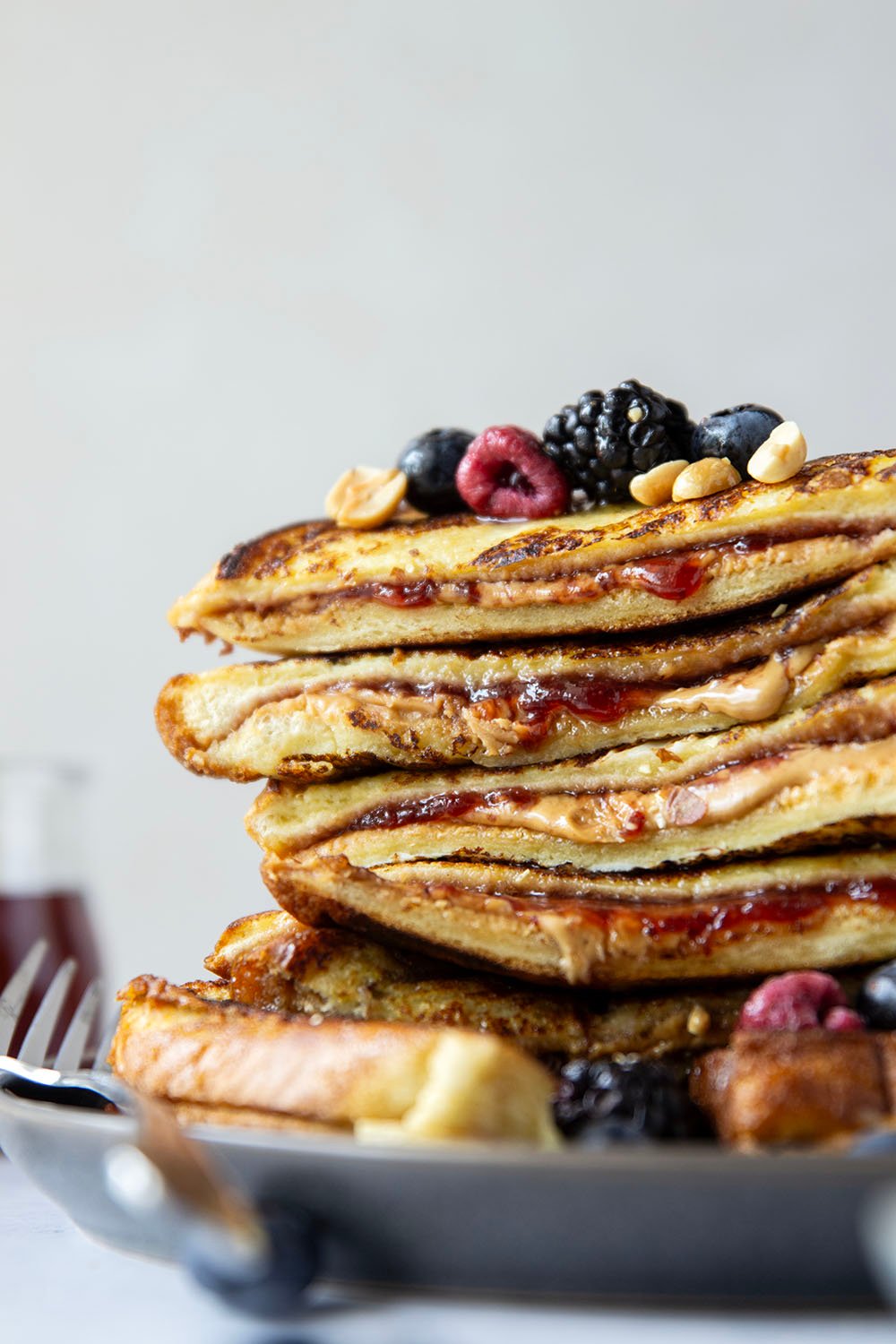 Stuffed with creamy peanut butter and sweet fruit jam, this peanut butter and jelly French toast is the best breakfast twist on a classic!