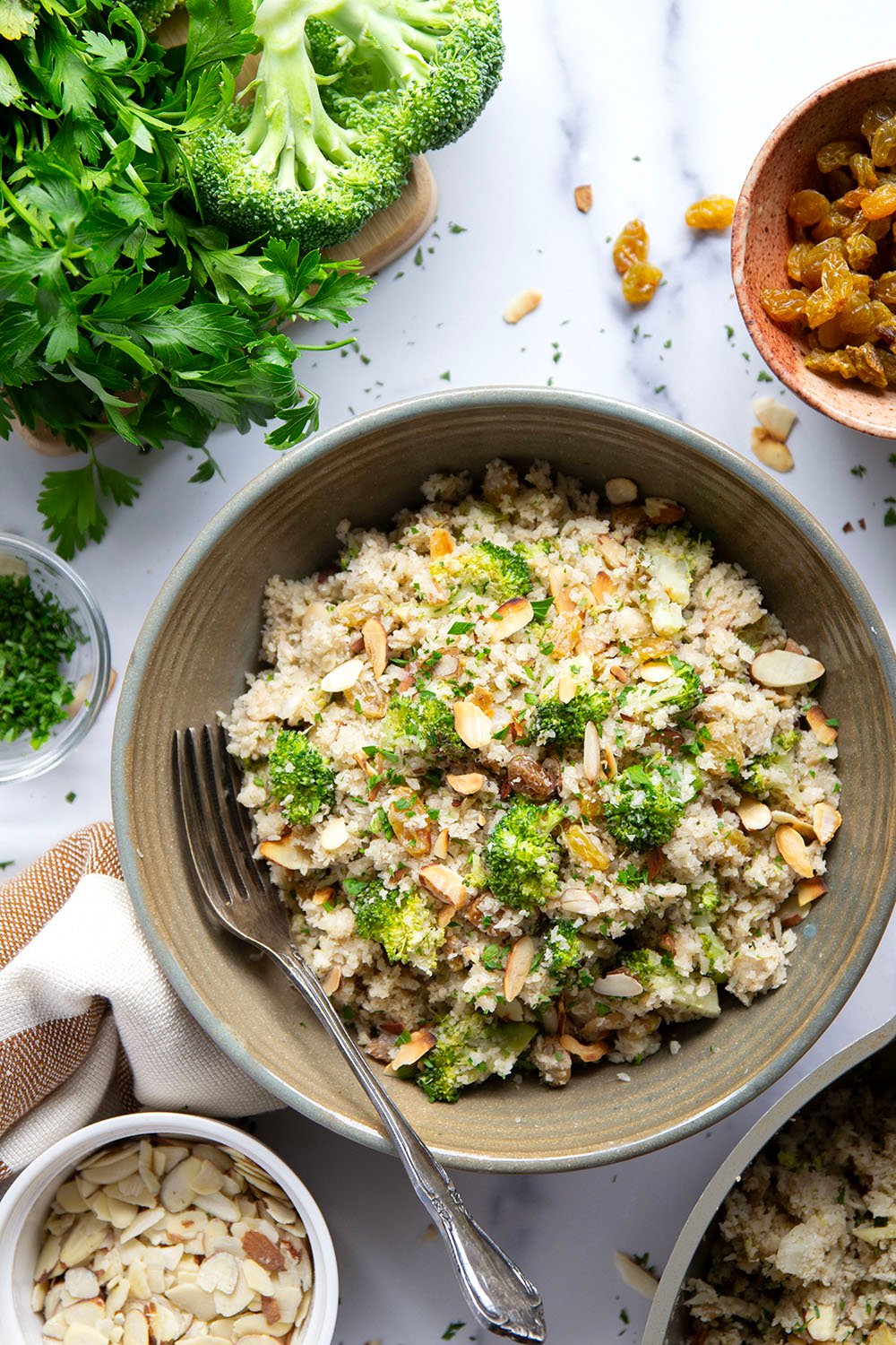 You won't believe that the base for this cauliflower rice pilaf is made entirely from riced cauliflower! It's unbelievably fluffy and jam-packed with tender broccoli, crunchy almonds and soft golden raisins.