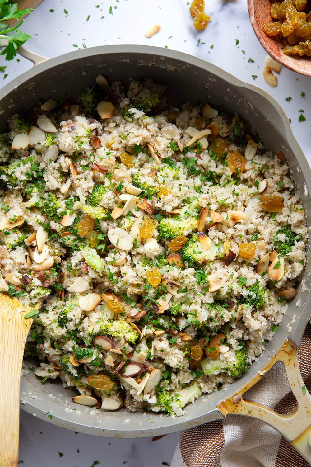 You won't believe that the base for this cauliflower rice pilaf is made entirely from riced cauliflower! It's unbelievably fluffy and jam-packed with tender broccoli, crunchy almonds and soft golden raisins.