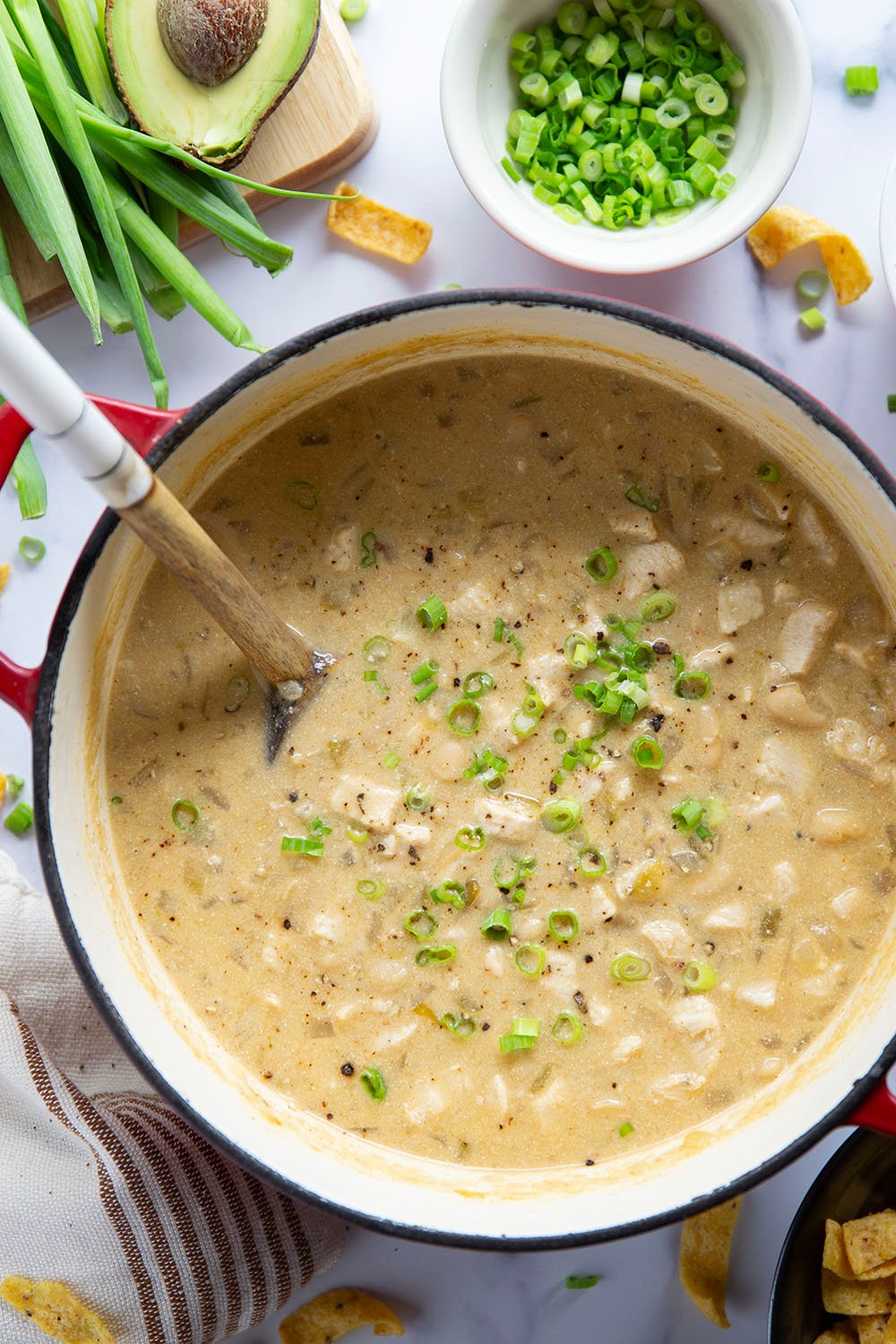 This white chicken chili is the ultimate comfort food! Loaded with lots of tender chicken and beans in a rich broth and piled high with all the toppings.