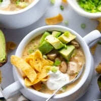 This white chicken chili is the ultimate comfort food! Loaded with lots of tender chicken and beans in a rich broth and piled high with all the toppings.