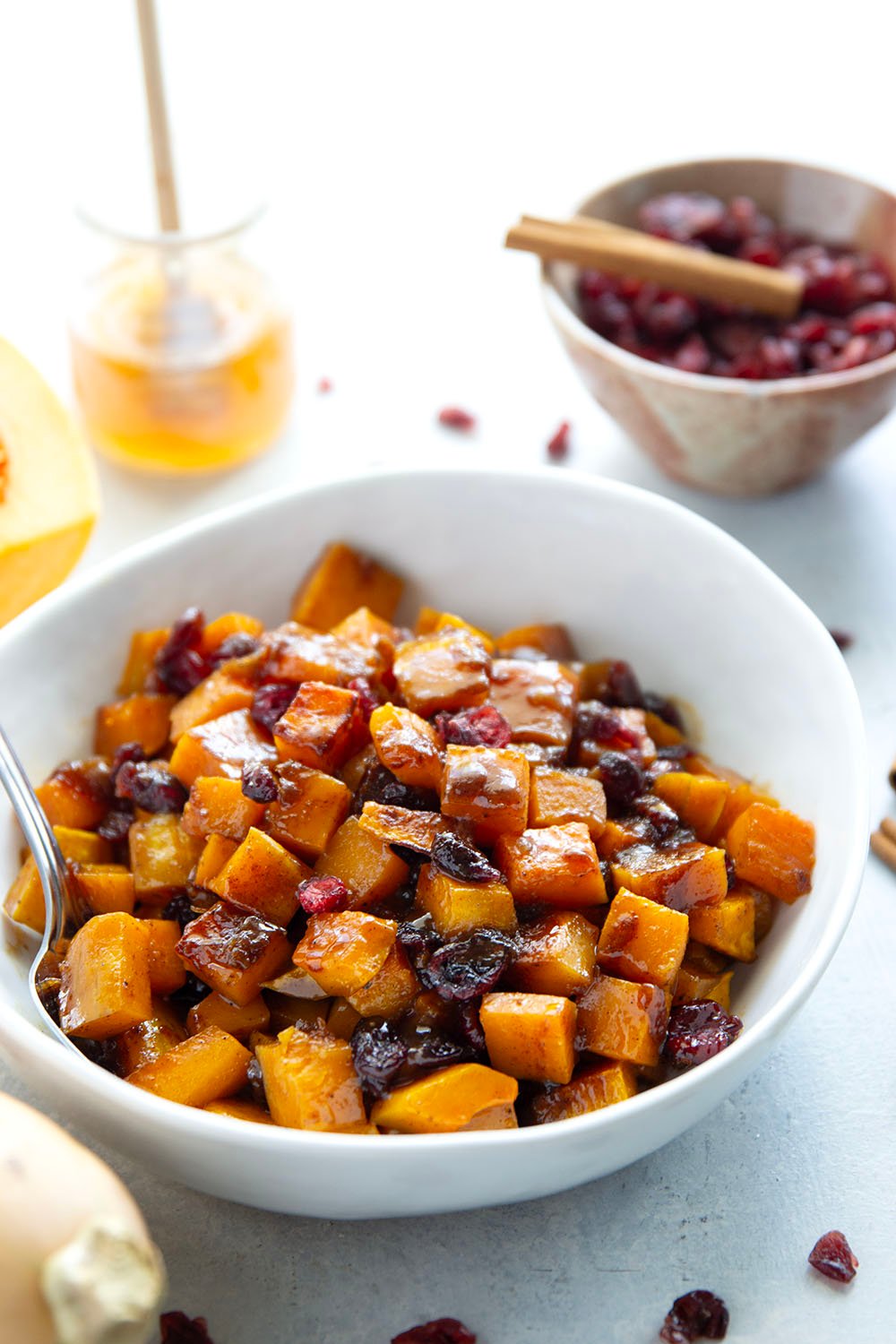 Roasted in a sweet spiced honey glaze and tossed with dried cranberries, this honey roasted butternut squash is an easy fall side dish that comes together in minutes!