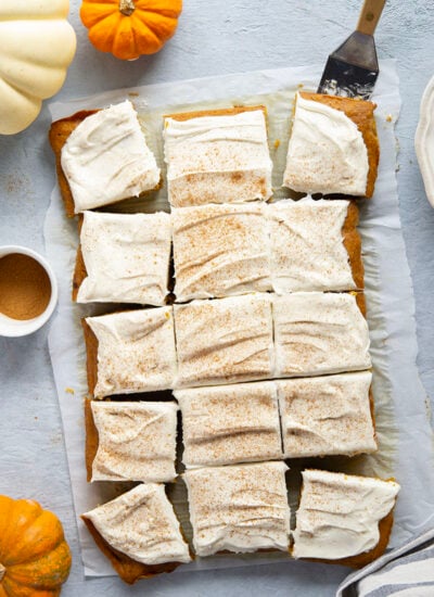 Creamy pumpkin and plenty of fall spices shine through in this super soft pumpkin sheet cake that gets frosted in a silky cream cheese frosting and is big enough to serve a crowd.