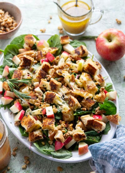 This apple walnut salad is simply loaded with crisp honeycrisp apples, crunchy walnuts, golden grilled cheese croutons and generously doused in a sweet apple cider vinaigrette.
