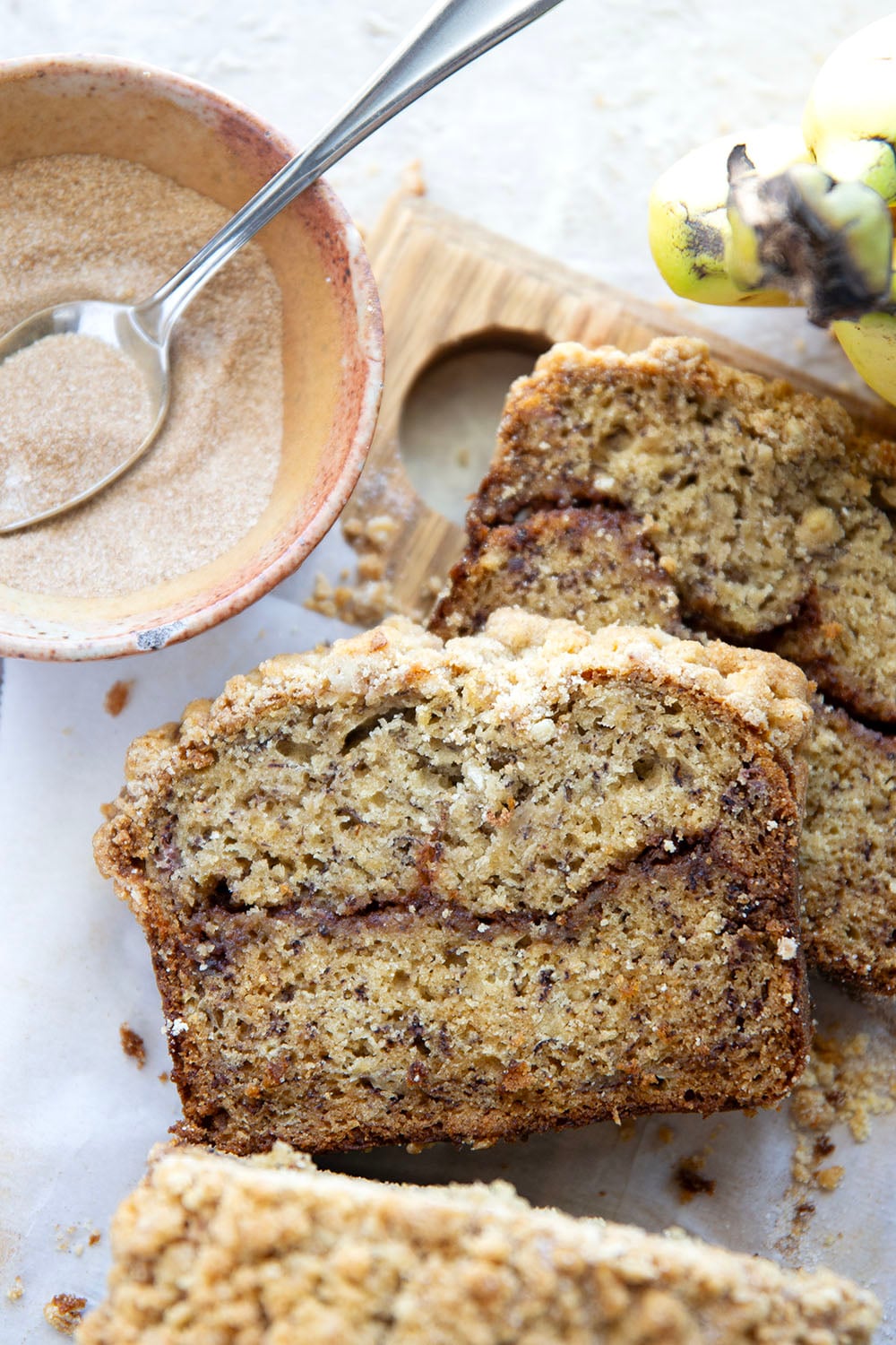 Coffee cake and banana bread collide into one irresistible loaf! This coffee cake banana bread features a soft texture with a cinnamon sugar ribbon in the center and lots of crunchy streusel baked on top.