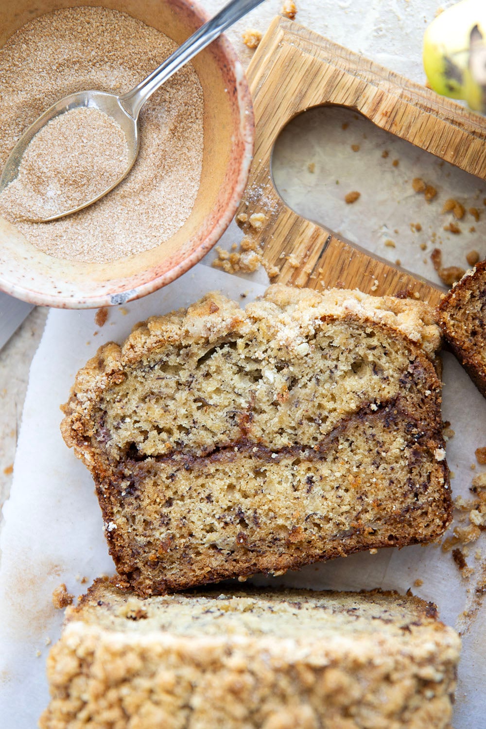 Coffee cake and banana bread collide into one irresistible loaf! This coffee cake banana bread features a soft texture with a cinnamon sugar ribbon in the center and lots of crunchy streusel baked on top.