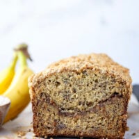 Coffee cake and banana bread collide into one irresistible loaf! This coffee cake banana bread features a soft texture with a cinnamon sugar ribbon in the center and lots of crunchy streusel baked on top.