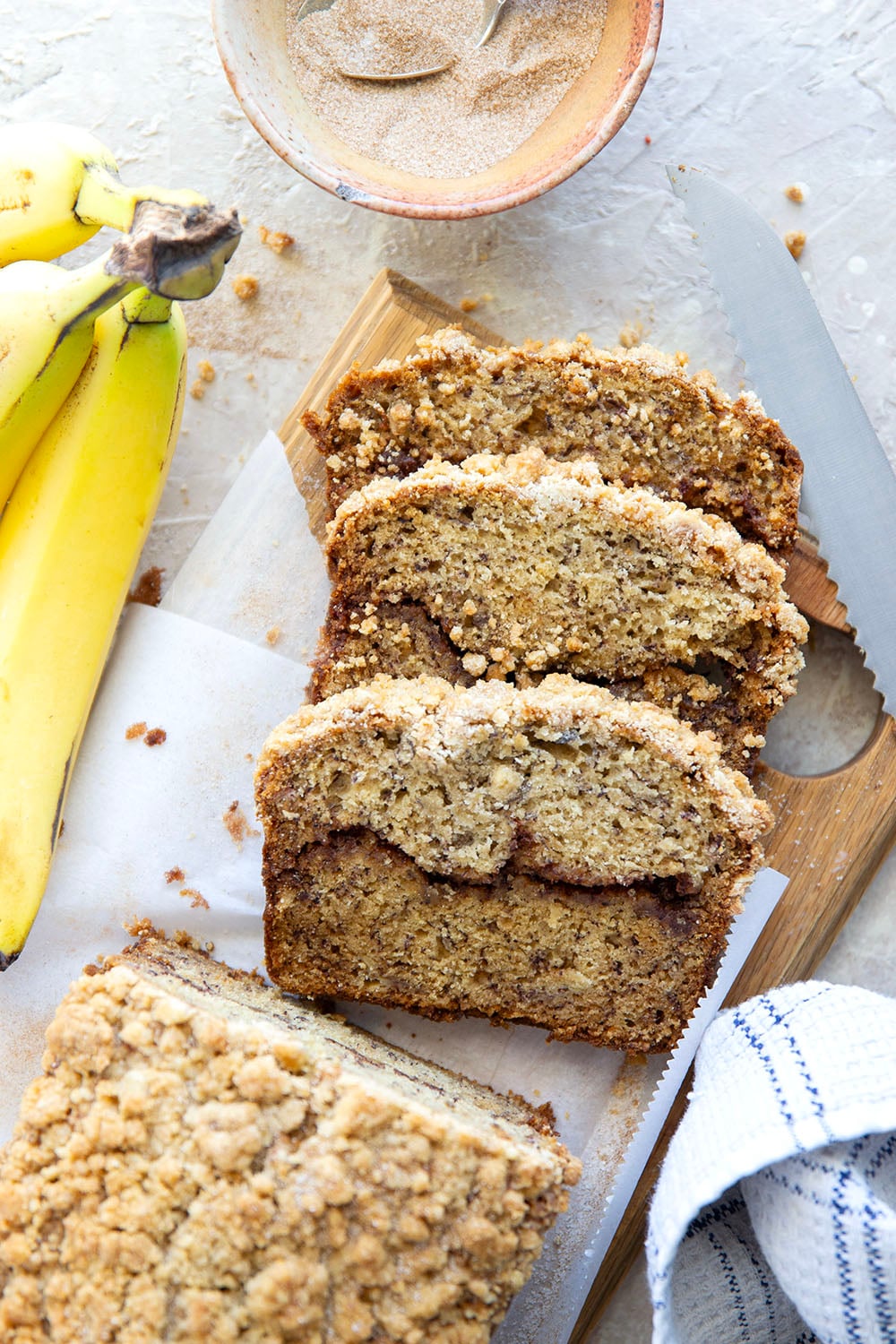 Coffee cake and banana bread collide into one irresistible loaf! This coffee cake banana bread features a soft texture with a cinnamon sugar ribbon in the center and lots of crunchy streusel baked on top.