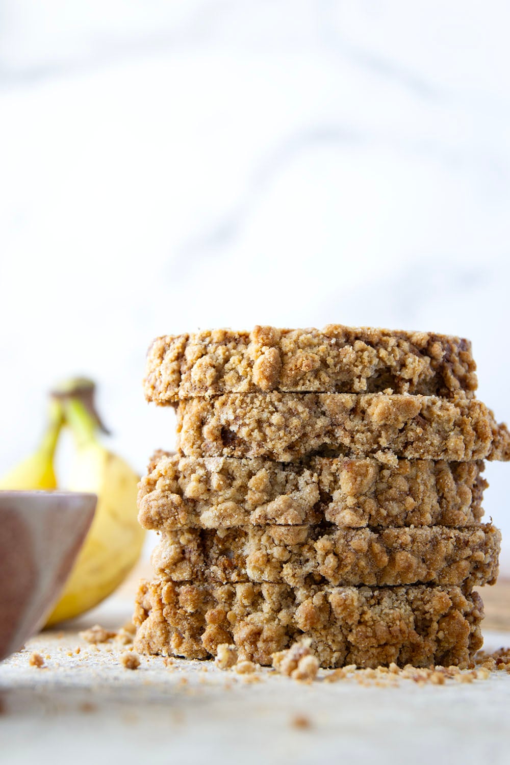 Coffee cake and banana bread collide into one irresistible loaf! This coffee cake banana bread features a soft texture with a cinnamon sugar ribbon in the center and lots of crunchy streusel baked on top.