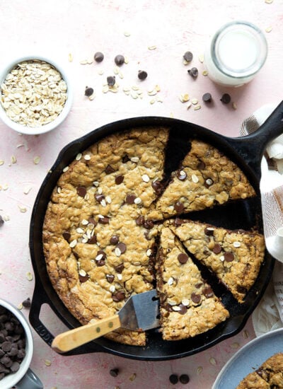 Soft and chewy chocolate chip oatmeal skillet cookie bakes up in only minutes in a cast iron skillet and is amazing with a scoop of vanilla ice cream on top!