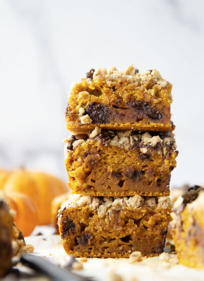 This luscious pumpkin chocolate chip coffee cake is packed with gooey chocolate chips and topped with a crunchy oatmeal streusel - the best fall breakfast ever!