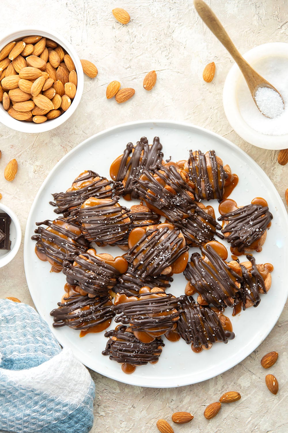 Roasted almonds, homemade caramel, and a good drizzle of dark chocolate come together in these dark chocolate almond clusters that whip up in minutes.