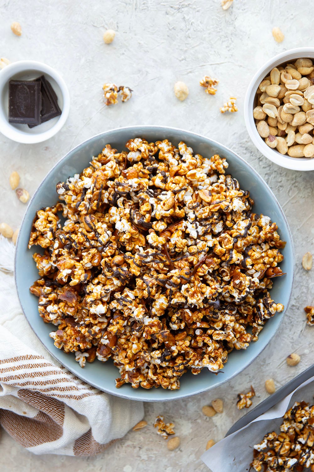 Covered in melted chocolate and caramel sauce and loaded with crunchy peanuts, this addicting caramel corn is the ultimate sweet snack!