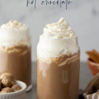 Chase away the winter chill with this eggnog hot chocolate that features winter spices, rich eggnog, and sweet hot chocolate all in one drink! Enjoy this easy holiday sipper hot or cold with lots of whipped cream on top.