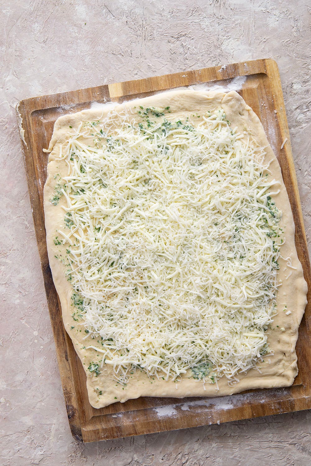 These garlic swirl rolls feature a soft and fluffy yeast bread base stuffed with a swirl of flavorful garlic herb butter and two kinds of cheese.