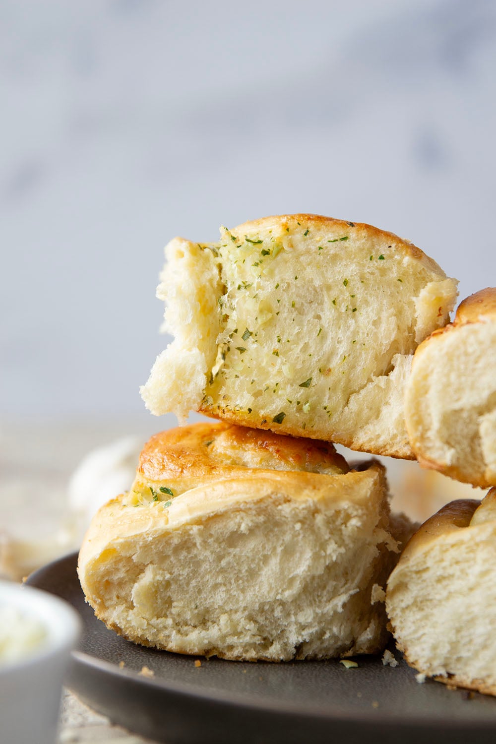 These garlic swirl rolls feature a soft and fluffy yeast bread base stuffed with a swirl of flavorful garlic herb butter and two kinds of cheese.
