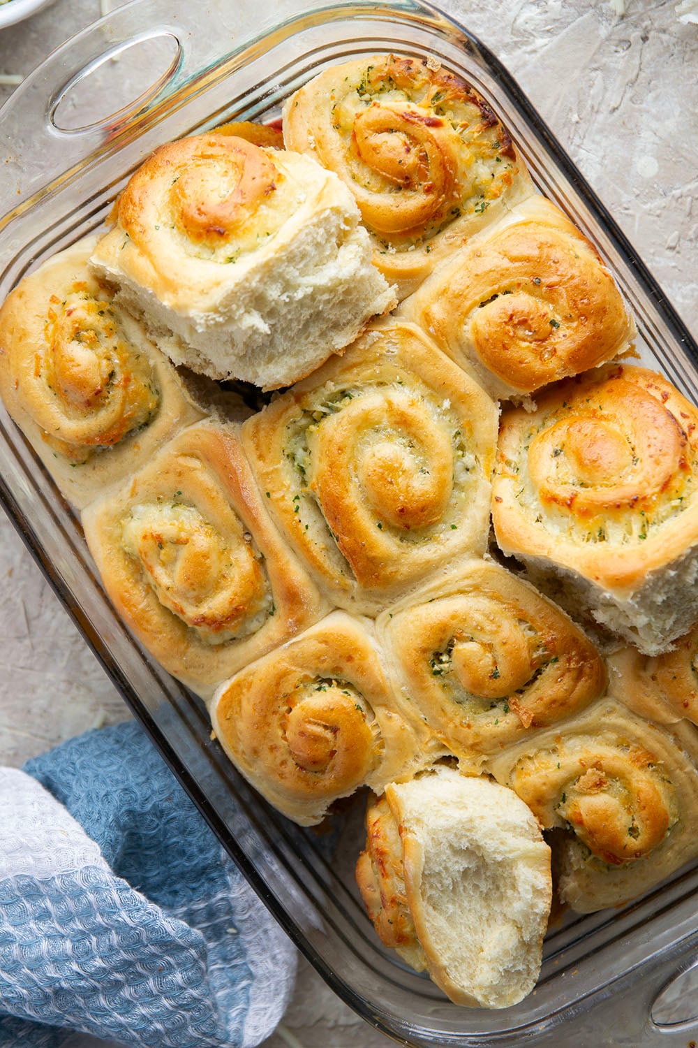 These garlic swirl rolls feature a soft and fluffy yeast bread base stuffed with a swirl of flavorful garlic herb butter and two kinds of cheese.