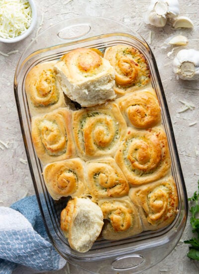 These garlic swirl rolls feature a soft and fluffy yeast bread base stuffed with a swirl of flavorful garlic herb butter and two kinds of cheese.