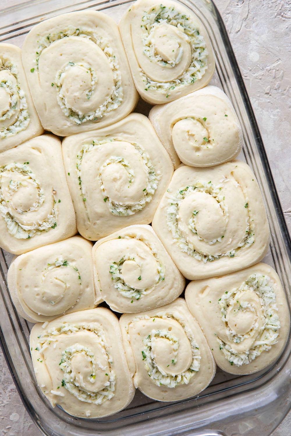 These garlic swirl rolls feature a soft and fluffy yeast bread base stuffed with a swirl of flavorful garlic herb butter and two kinds of cheese.