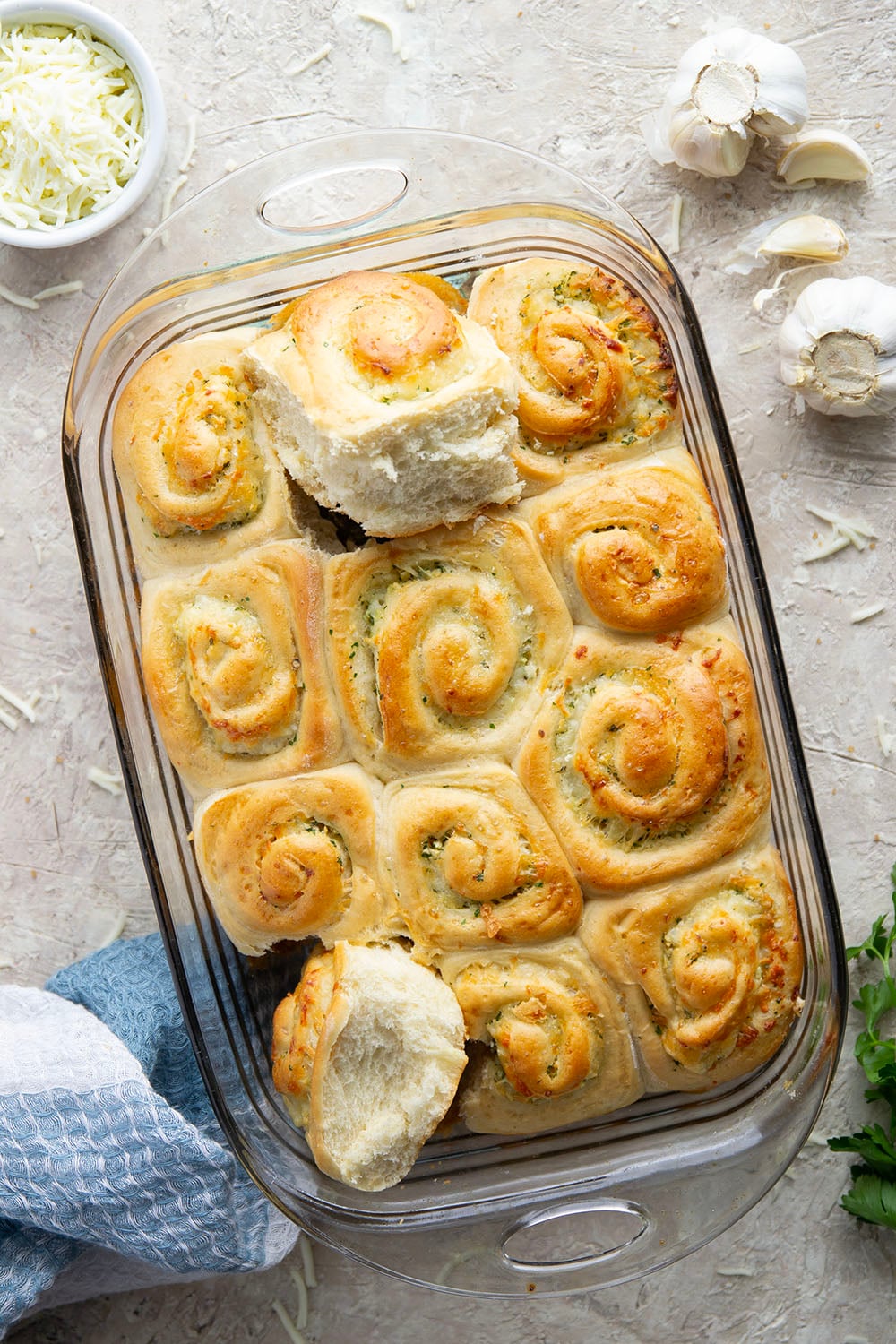 These garlic swirl rolls feature a soft and fluffy yeast bread base stuffed with a swirl of flavorful garlic herb butter and two kinds of cheese.