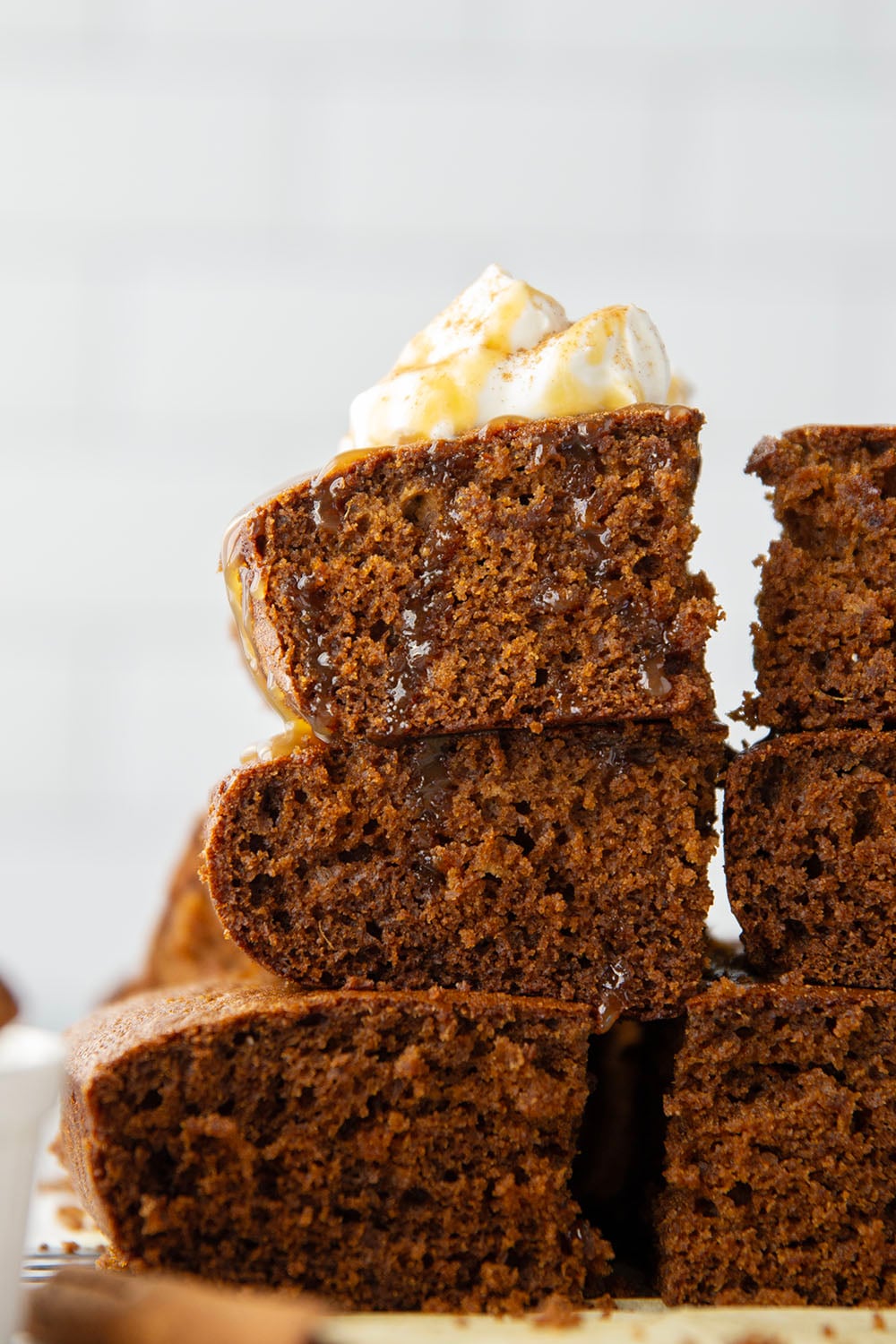 Old-fashioned gingerbread cake is a must around the holidays! This simple cake is perfectly spiced, incredibly moist, and the best Christmas dessert with a dollop of whipped cream and caramel sauce on top.