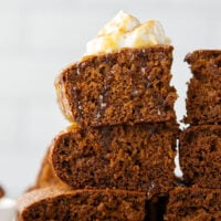 Old-fashioned gingerbread cake is a must around the holidays! This simple cake is perfectly spiced, incredibly moist, and the best Christmas dessert with a dollop of whipped cream and caramel sauce on top.