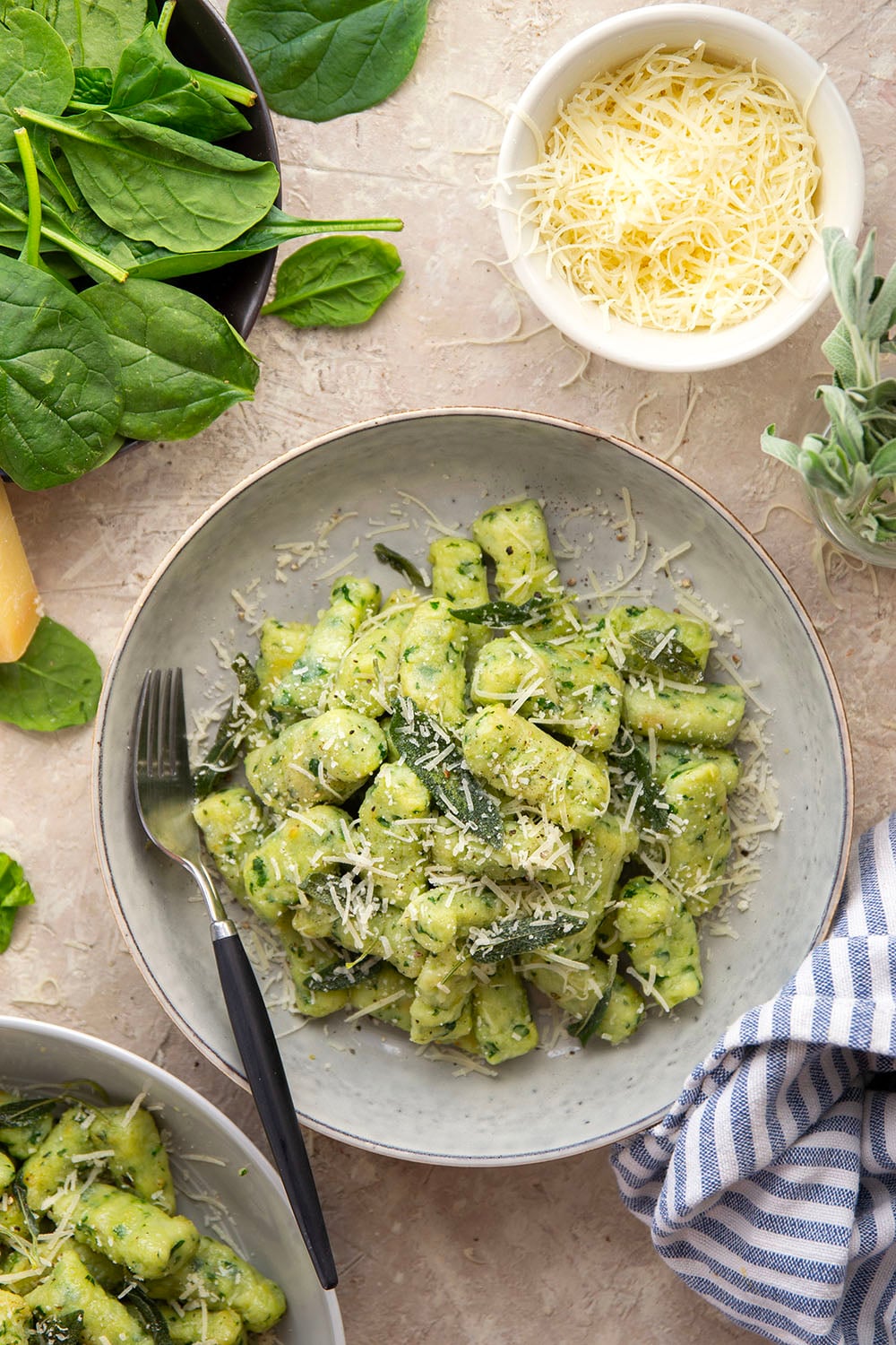 Light and fluffy homemade spinach gnocchi is packed with vibrant fresh spinach and tossed in a sage browned butter and lots of fresh Parmesan.