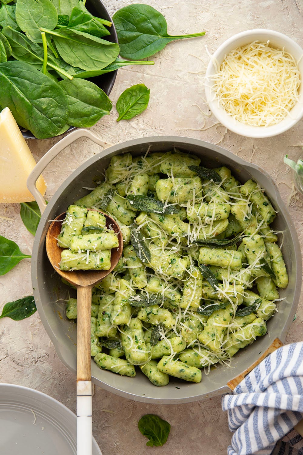 Light and fluffy homemade spinach gnocchi is packed with vibrant fresh spinach and tossed in a sage browned butter and lots of fresh Parmesan.