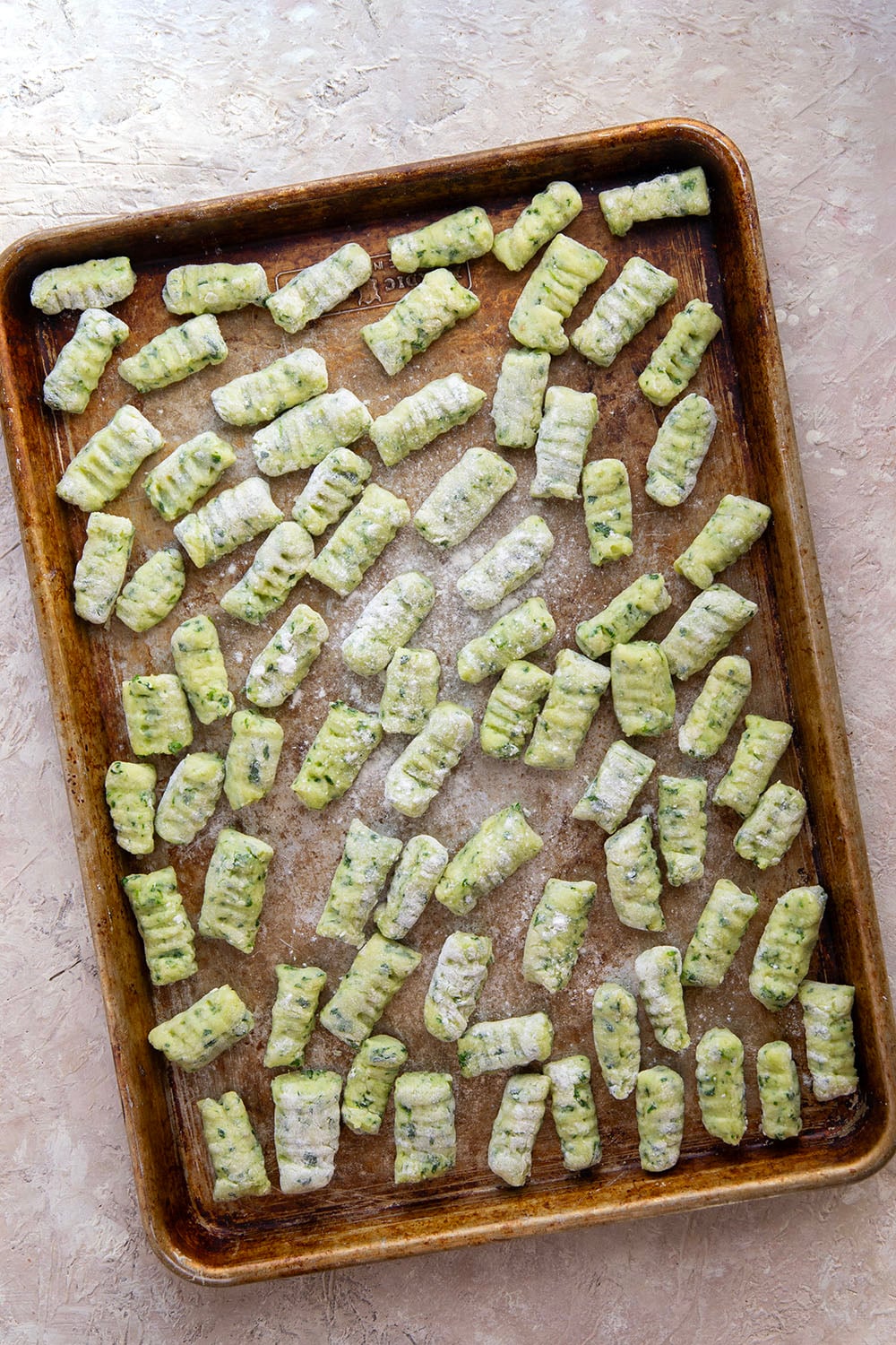 Light and fluffy homemade spinach gnocchi is packed with vibrant fresh spinach and tossed in a sage browned butter and lots of fresh Parmesan.