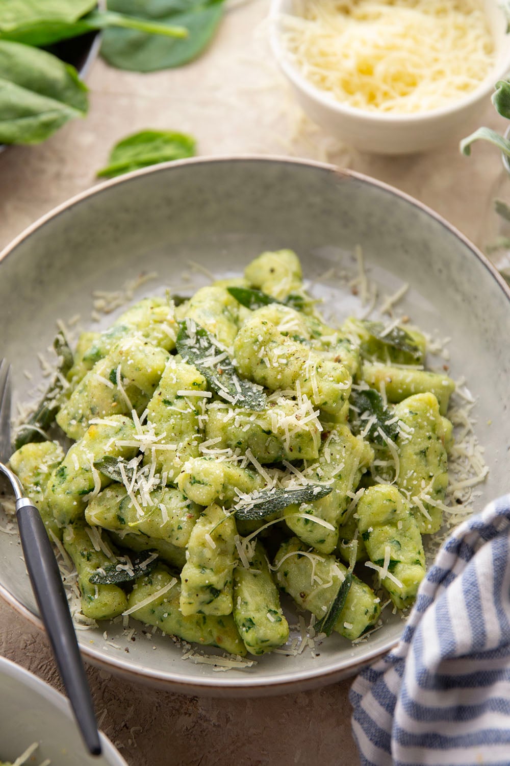 Light and fluffy homemade spinach gnocchi is packed with vibrant fresh spinach and tossed in a sage browned butter and lots of fresh Parmesan.