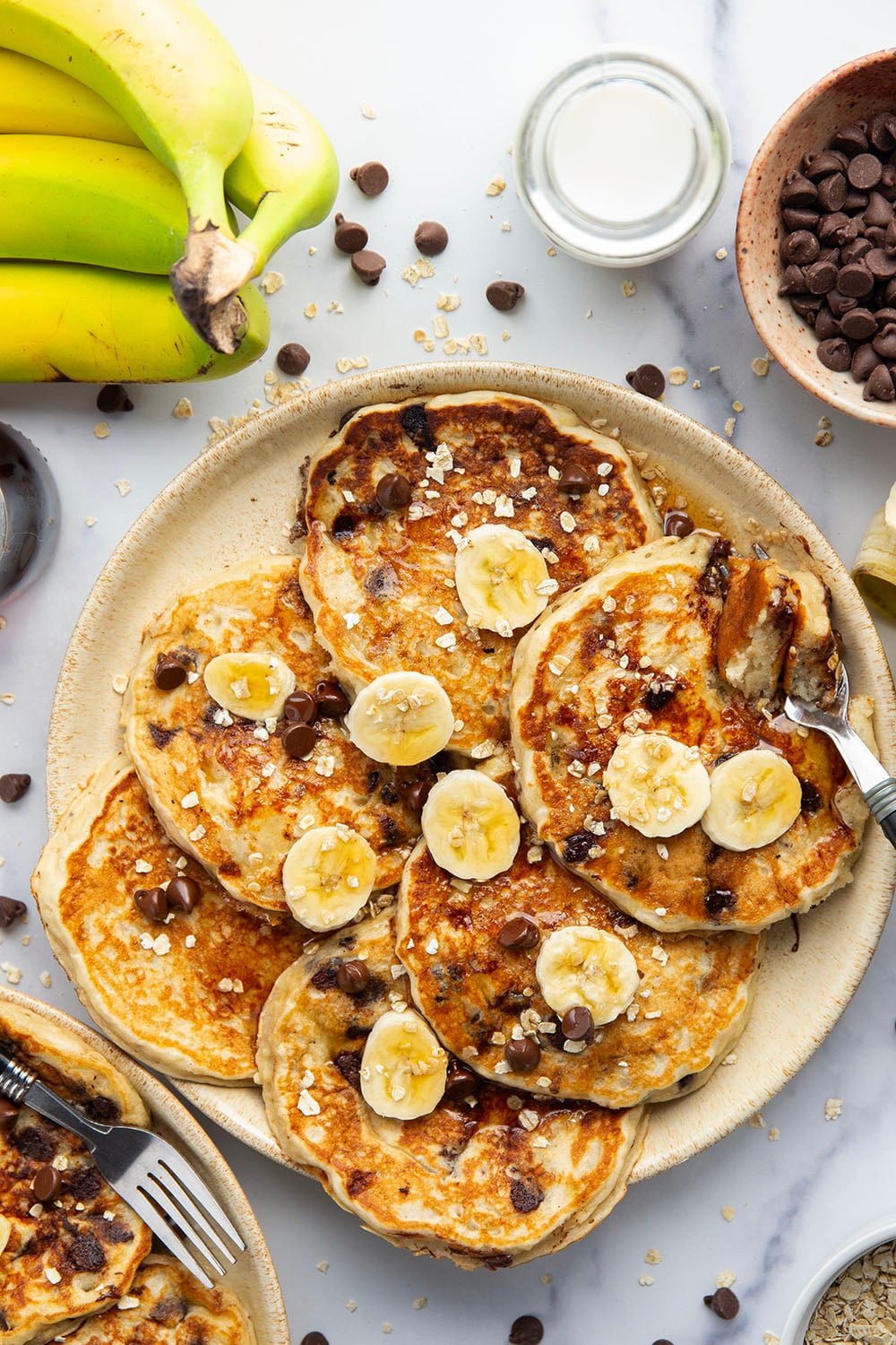 Loaded with lots of banana, hearty oats, and gooey chocolate chips, these fluffy chocolate chip oatmeal pancakes are the ultimate breakfast stack and perfect for the weekend.