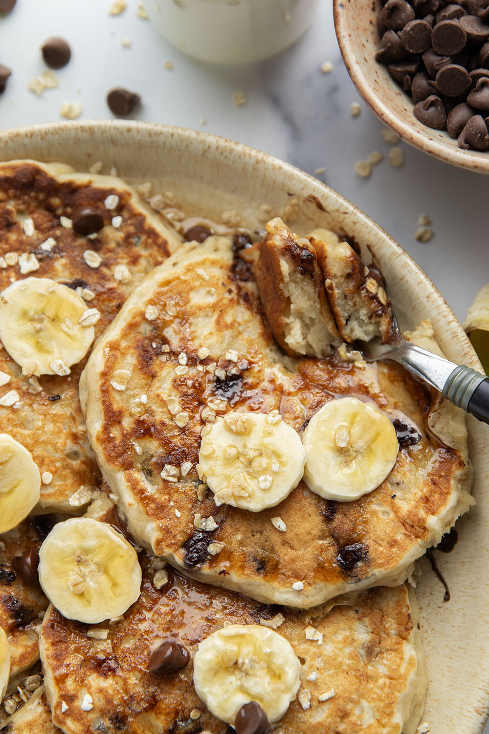 Loaded with lots of banana, hearty oats, and gooey chocolate chips, these fluffy chocolate chip oatmeal pancakes are the ultimate breakfast stack and perfect for the weekend.